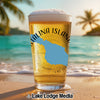 Glass of beer with "Catalina Island" text and blue island shape on a beach.