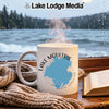White mug with Lake Moultrie South Carolina map design sits by a window.