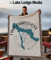 Woven blanket featuring a teal map of Lake Charlevoix, Michigan with compass rose.