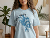 Light blue t-shirt with Lake Tapps Washington map graphic and compass details.