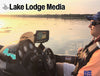 Man in boat at sunset with a fish finder and "Lake Lodge Media" logo.