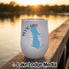 A white insulated wine tumbler with a blue map of Peyto Lake rests on a wooden dock at sunset.