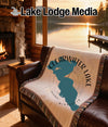 Woven blanket with Clearwater Lake, Minnesota design on a couch.