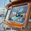 Turquoise Redfish Life sticker on a boat window, and "Lake Lodge Media" text.