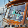 Turquoise Canyon Life sticker on a wooden boat window with "Lake Lodge Media" text.