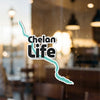 Chelan Life sticker with turquoise water wave design and copyright text.
