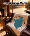 Woven blanket with Lake Okeechobee, Florida map design on a leather couch.