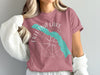 Eklutna Lake Alaska graphic on a pink t-shirt with compass and water silhouette.