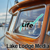 Ullswater Life logo and Lake Lodge Media text on a wooden boat window.