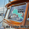 Teal lake decal with "Clear Life" text on a wooden boat window.