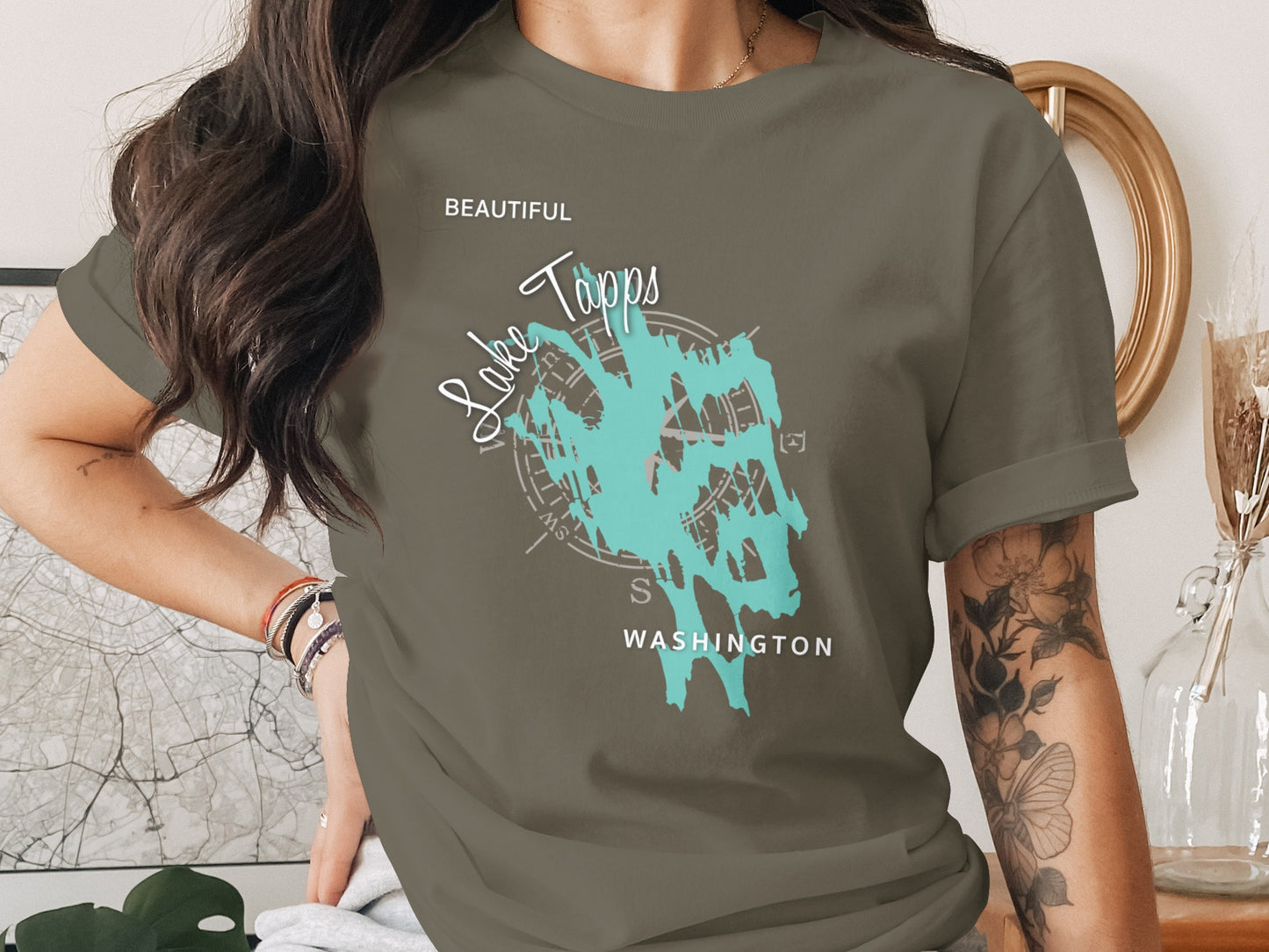 Olive t-shirt with turquoise abstract lake graphic and "Beautiful Tapps Washington" text.