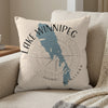 Light-colored pillow featuring a blue outline map of Lake Winnipeg and text.