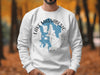 White sweatshirt with Lake Massabesic map and compass design in blue and gray.