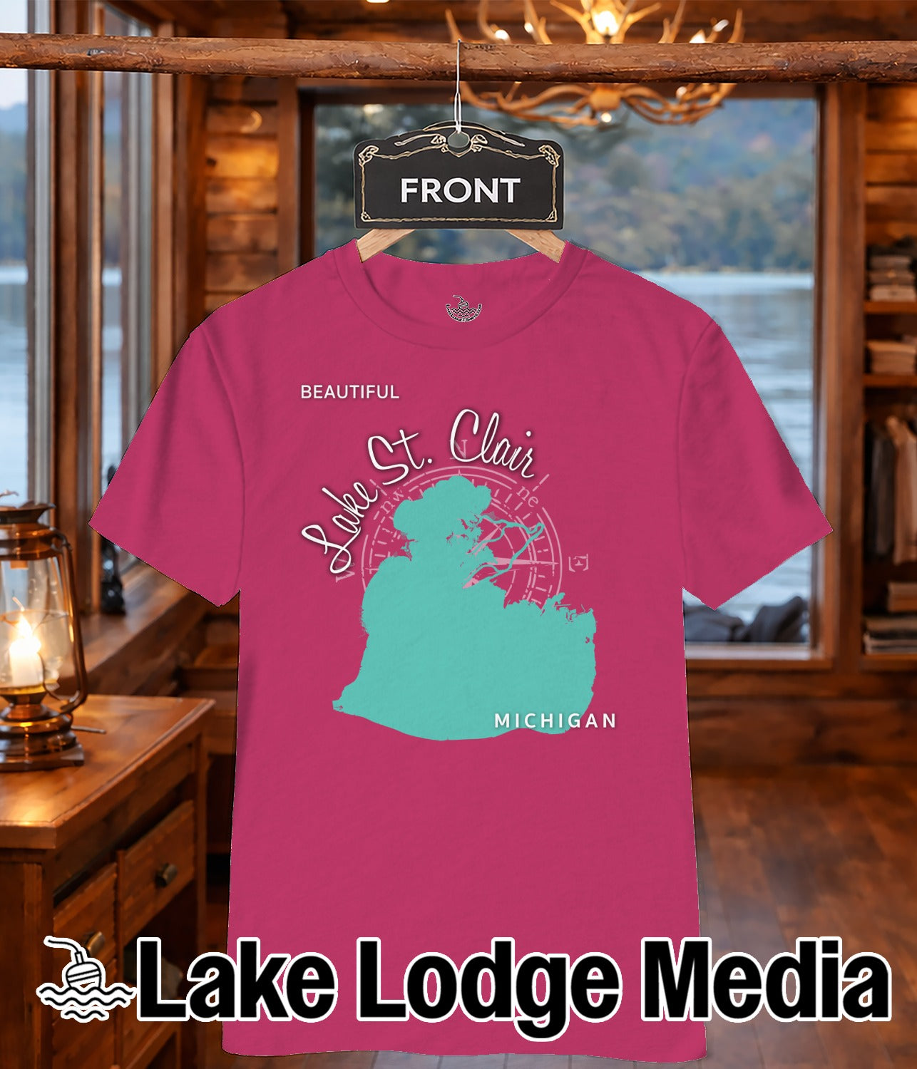 Pink t-shirt featuring a teal map of Lake St. Clair and "Lake Lodge Media" logo.