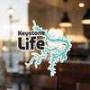 Keystone Life decals with teal lake outline and copyright text on a window.