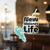 Turquoise lake outline sticker with black text "New Melones Life" on a window.