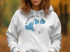 White hoodie with Merrymeeting Lake graphic and compass design.