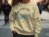 Light yellow crewneck sweatshirt with Tims Ford Lake map and compass design.