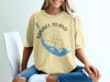 Yellow t-shirt with Sanibel Island map and compass graphic, "Sanibel Island Florida" text.