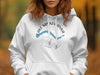 White hoodie with "Lake Minnewanka" text and compass graphic.