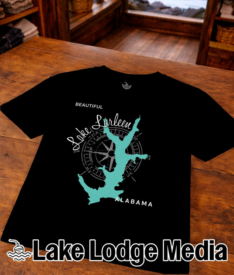 Black t-shirt with teal Lake Lurleen and Alabama graphic, compass rose, and text.
