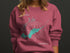 Cedar Lake compass graphic with map outline on a mauve sweatshirt.