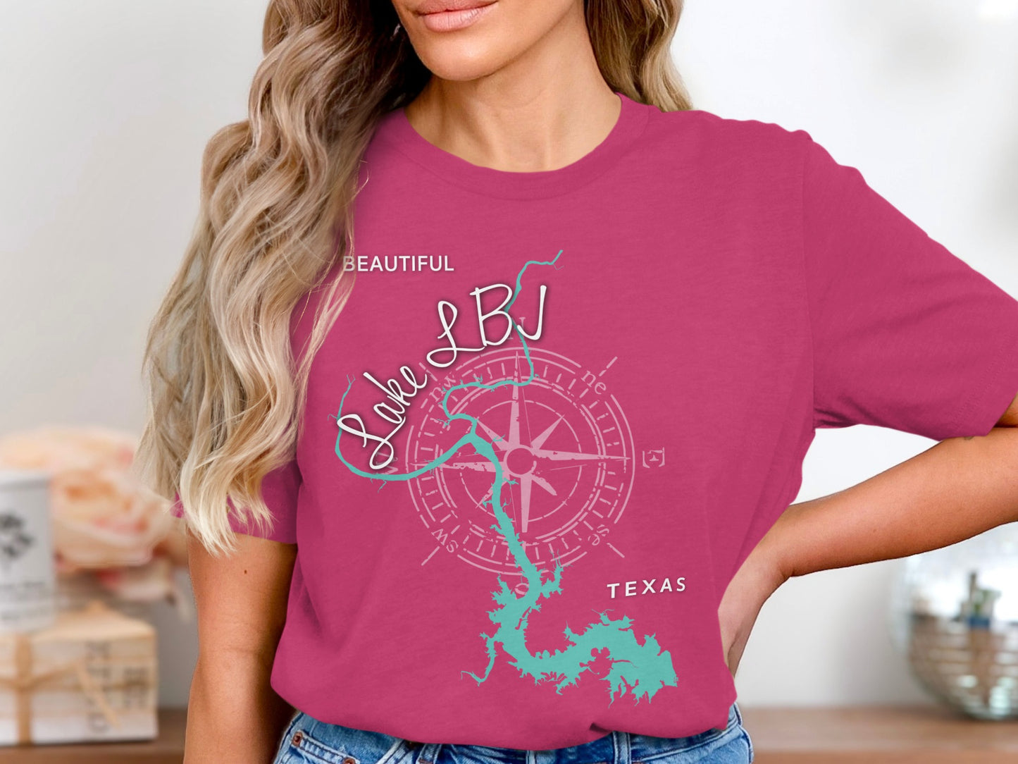 Woman wearing pink t-shirt with Lake LBJ map and compass design, Texas.