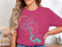 Woman wearing pink t-shirt with Lake LBJ map and compass design, Texas.