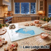 A glass cutting board featuring a blue map of Sylvan Lake, South Dakota, surrounded by holiday baking supplies on a kitchen counter.