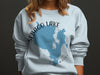 Light blue sweatshirt with Sebago Lake Maine map and compass graphic.