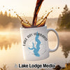 White mug with Lake Ray Hubbard map and compass design, coffee pouring.