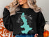 Black sweatshirt with "Beautiful West Okoboji Lake Iowa" graphic.