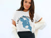 White t-shirt with blue Lake Kissimmee Florida map graphic and compass rose.