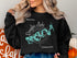 Black sweatshirt with turquoise map of Douglas Lake and compass rose.