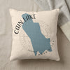 Cain Lake Washington map on cream textured pillow with gray blanket.