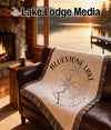 Fringed throw blanket with Bluestone Lake West Virginia compass design on leather couch.