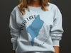 Light blue sweatshirt with Alta Lake Washington map and compass graphic.