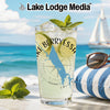 Glass of Lake Berryessa drink with lime, mint, and ice on a beach.