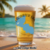 Clear glass of beer with "Clearwater" and "Minnesota" text on a beach.