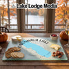 A glass cutting board featuring a map of Onondaga Lake rests on a wooden table.