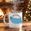 White mug with Lake McConaughy, Nebraska design, splashing coffee, cozy fireplace, Christmas tree.