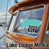 Turquoise Walden Life sticker on a boat window, with "Lake Lodge Media" text.