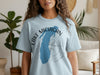 Light blue t-shirt with Lake Michigan silhouette and compass graphic.