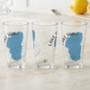 Three clear glasses each featuring a blue Lake Tahoe map silhouette and text.