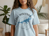Light blue t-shirt with "Lake Wisconsin" and compass graphic, including lake outline.