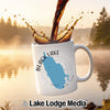 White mug with "Black Lake New York" and compass design, with coffee pouring in.