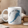 White mug with blue Lake Las Vegas outline and compass graphic.