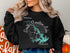 Black sweatshirt with "Beautiful Smith Mountain Lake Virginia" graphic.
