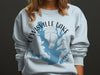 Light blue sweatshirt with Lewisville Lake map graphic and text.