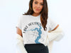 White t-shirt with "Lake Houston Texas" and blue lake map graphic with compass